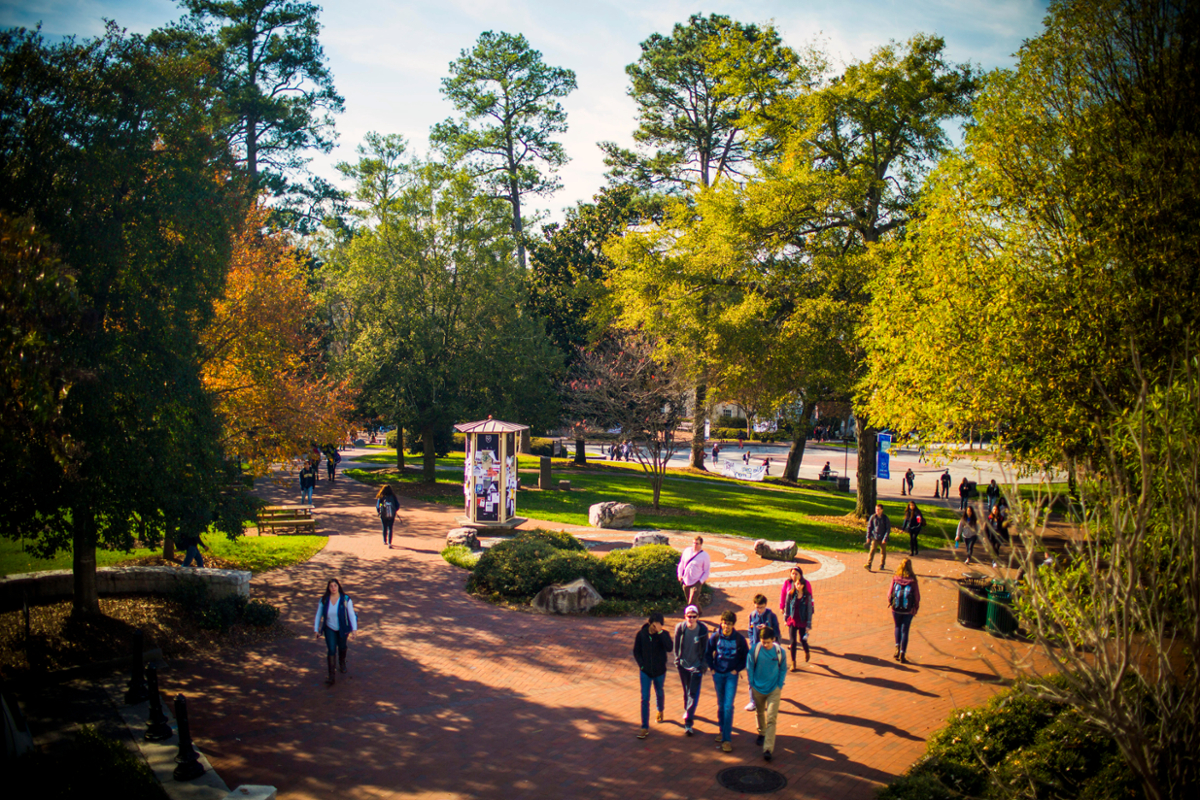 Photo of student walking around Asbury Circle on Emory's campus